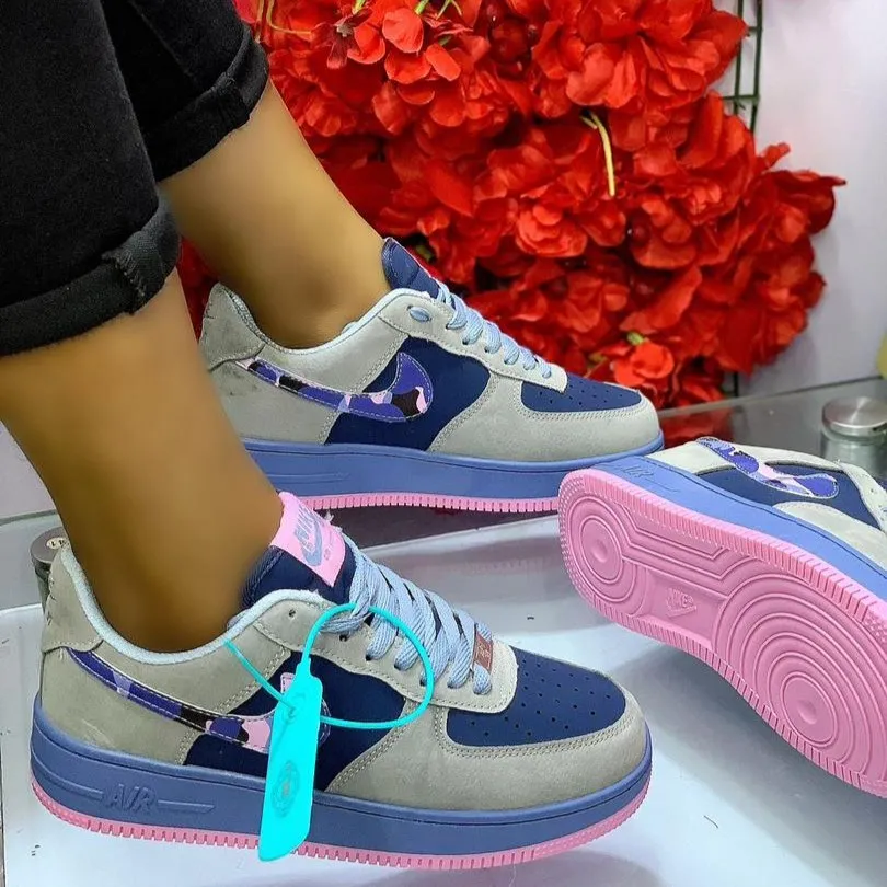 Nike Air Force 1 Sneakers in a Grey, Navy, and Pink Colorway.